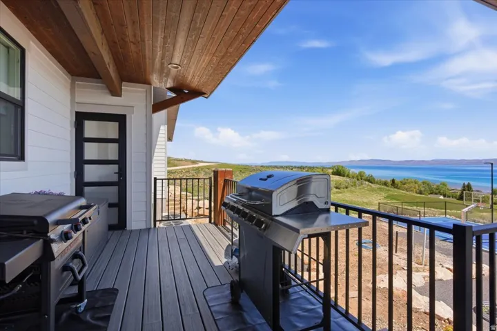 Expansive outdoor deck featuring wood-finish ceiling, gray composite decking, and black metal railings