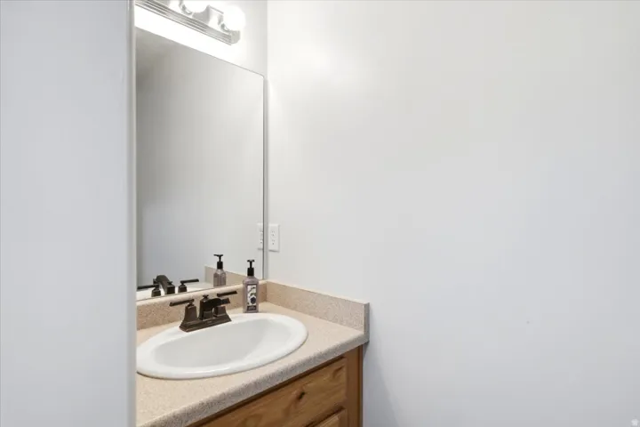 Recessed sink with a bronze-finish faucet, set into a stone-finish countertop