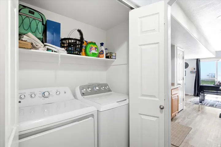 Dedicated laundry area with built-in shelving, providing ample storage