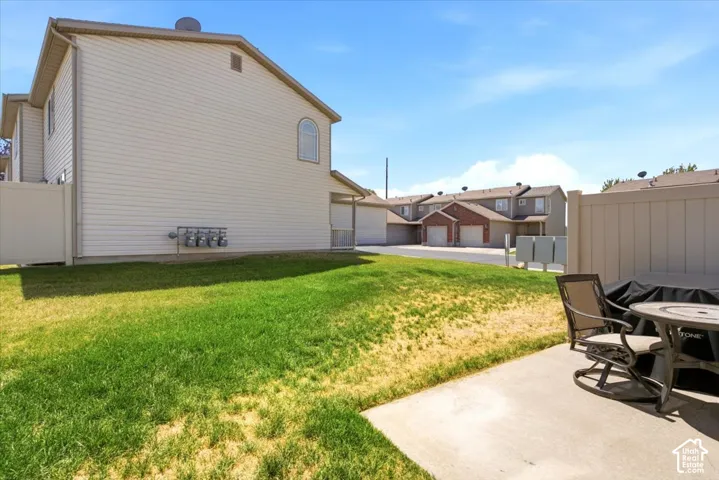 Expansive grassy area with a concrete patio