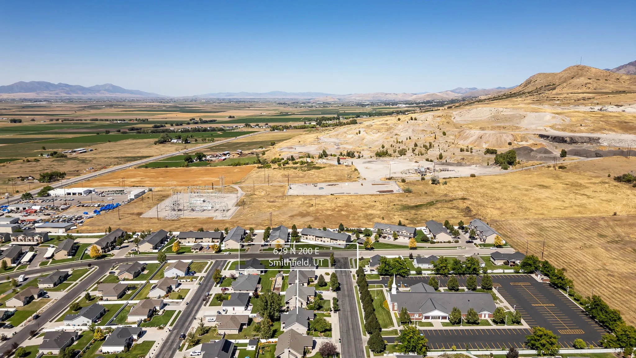 Residential neighborhood with established homes, paved streets, and a mountainous backdrop