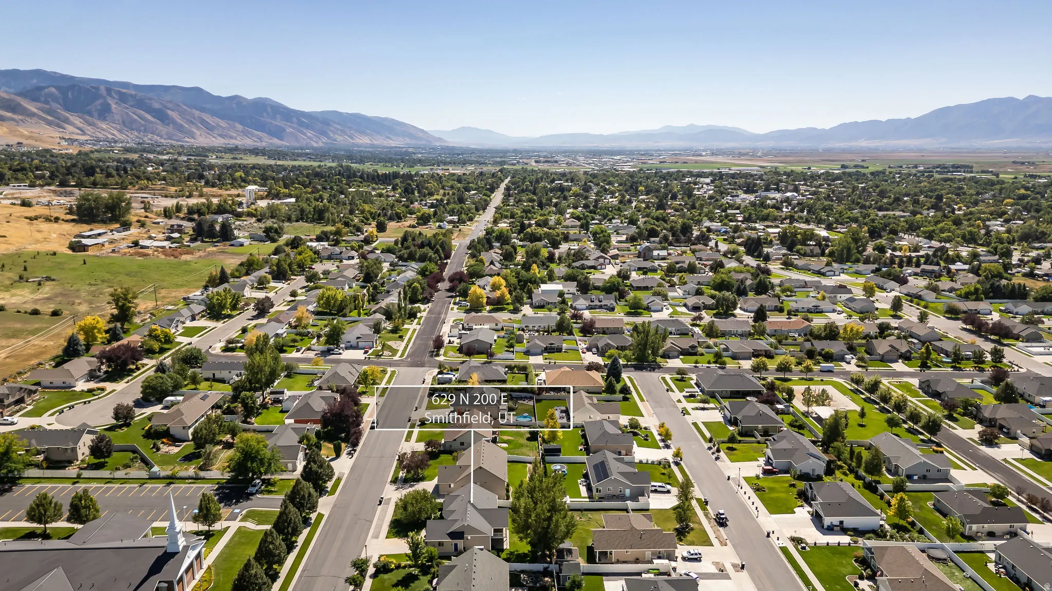 Residential neighborhood with established homes, paved streets, and a mountainous backdrop