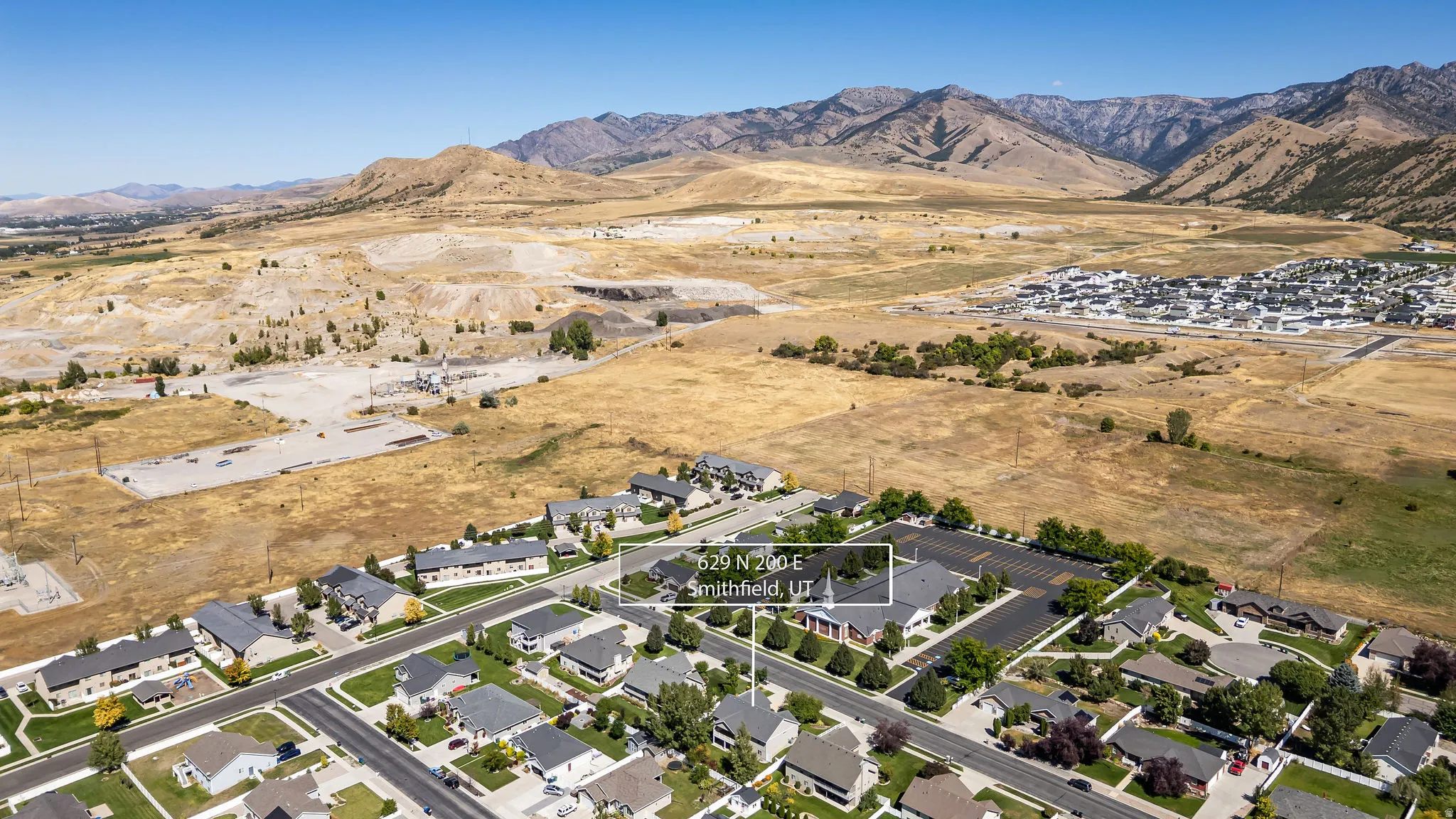 Residential neighborhood with established homes, paved streets, and a mountainous backdrop