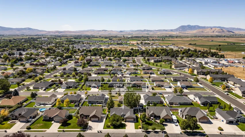 Residential neighborhood with established homes, paved streets, and a mountainous backdrop