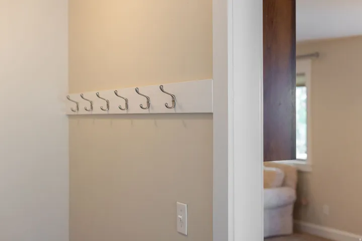 Wall-mounted coat rack featuring multiple hooks
