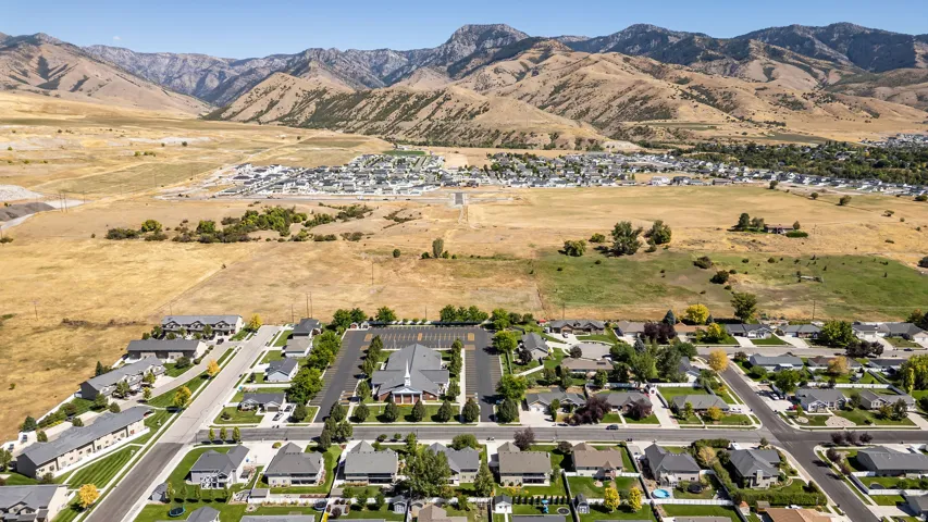 Residential neighborhood with established homes, paved streets, and a mountainous backdrop