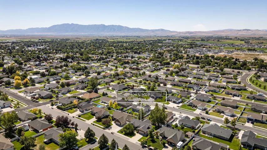 Residential neighborhood with established homes, paved streets, and a mountainous backdrop