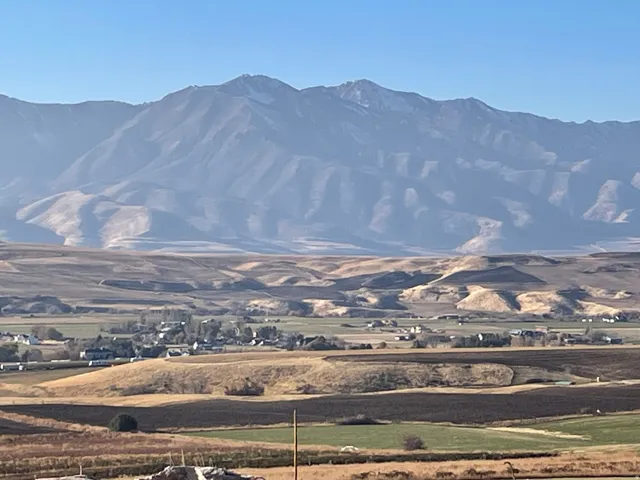 Expansive mountain range backdrop with a clear sky