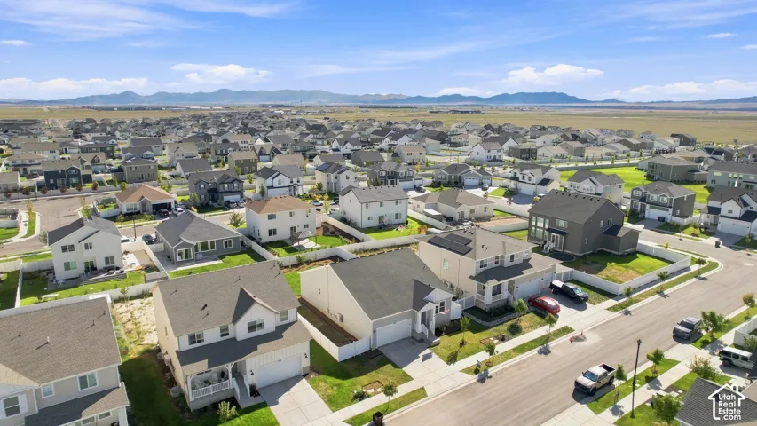 Suburban neighborhood with varied architectural styles and mountain scenery