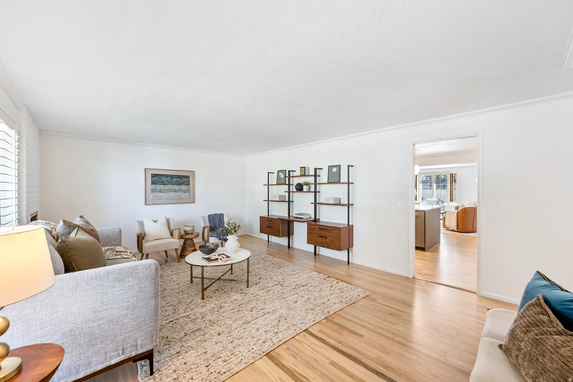 Wood-finish flooring throughout, white walls, and a recessed opening