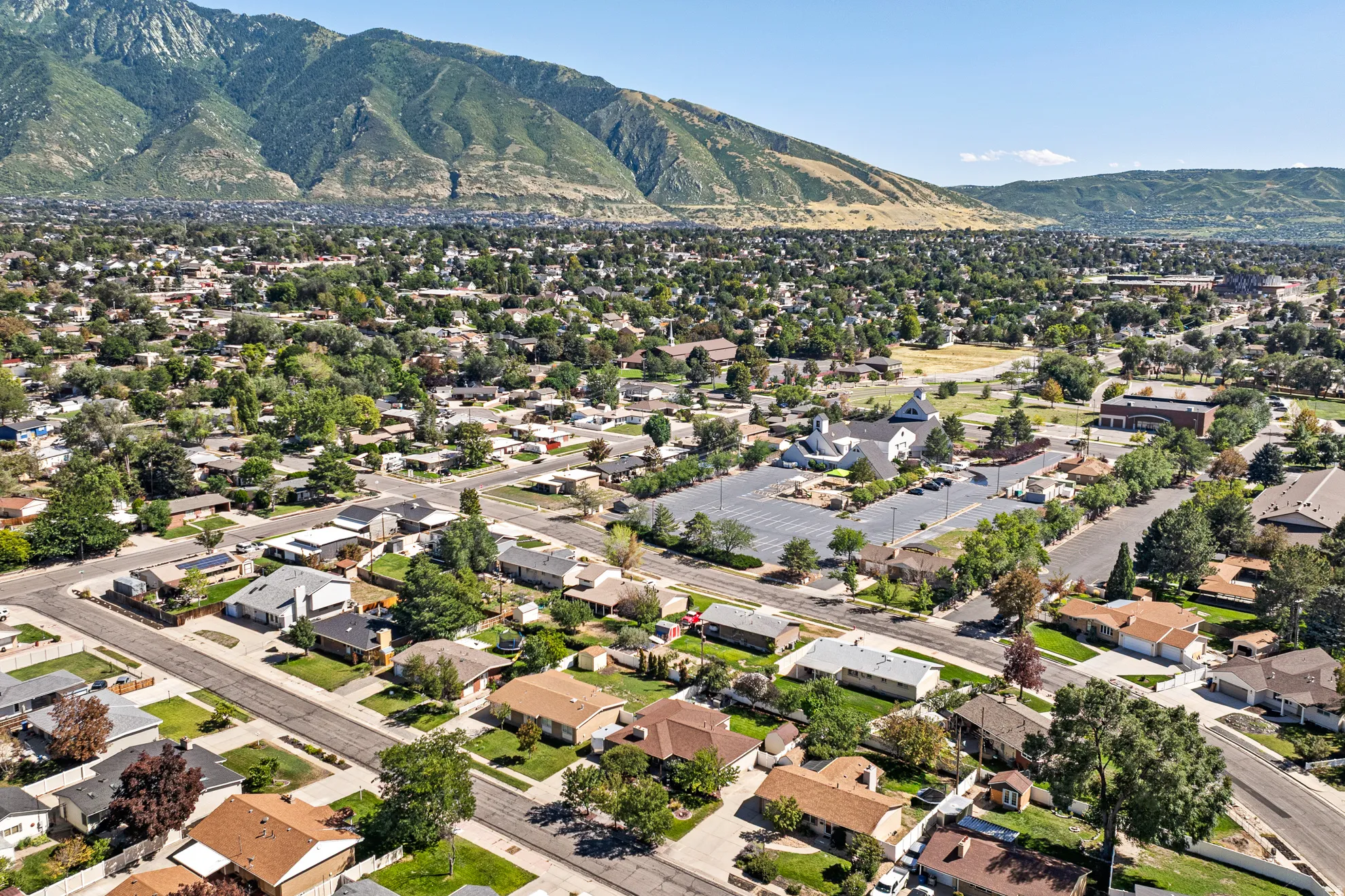 Residential neighborhood with established landscaping and mountain backdrop