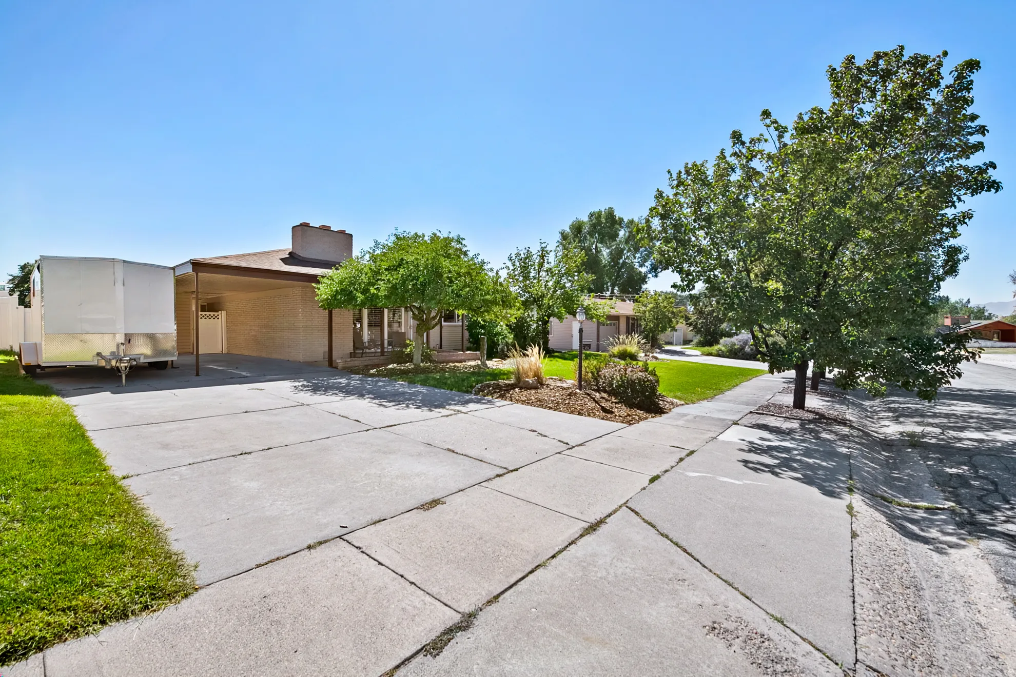 Front driveway, brick exterior with an attached carport