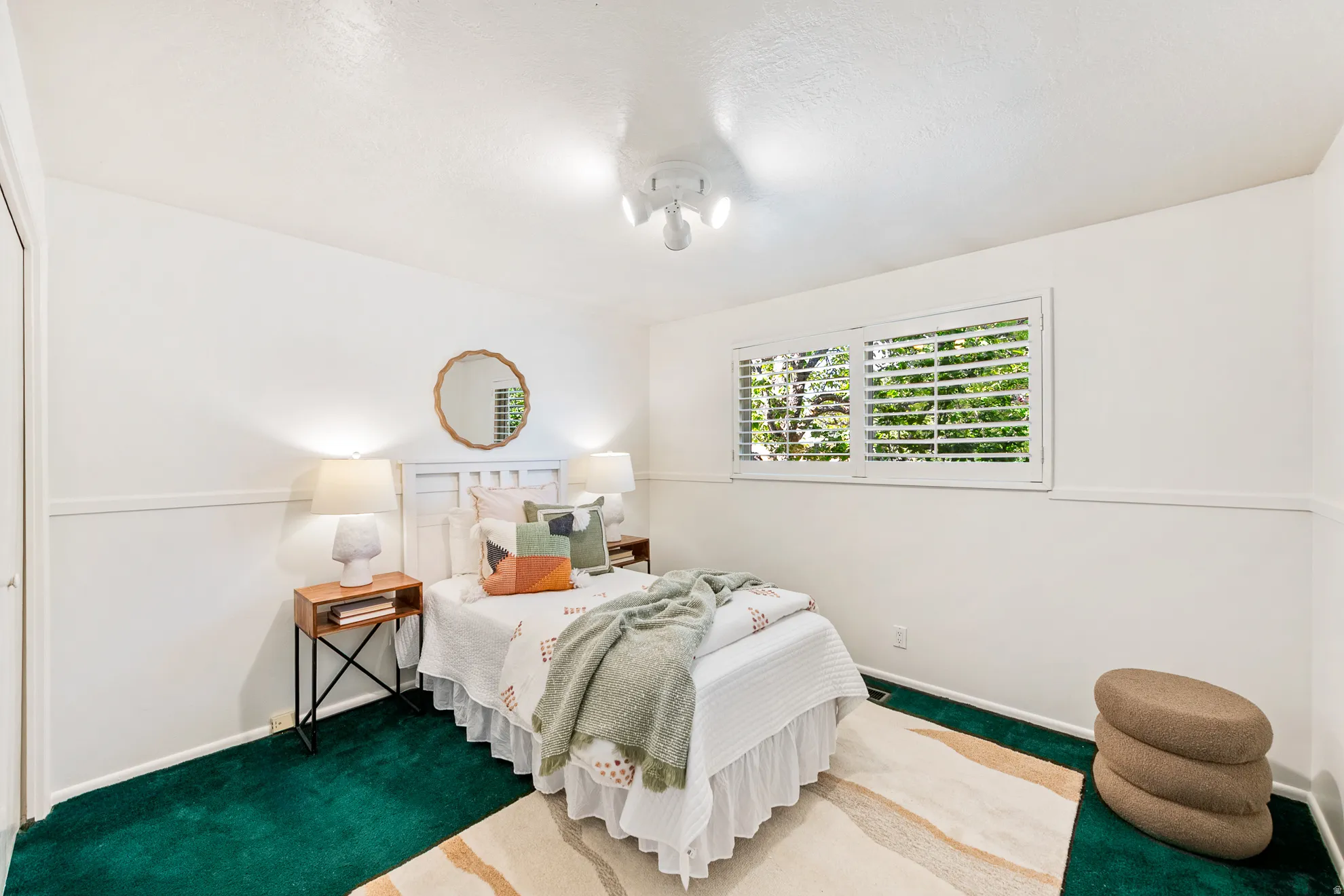 Spacious bedroom with fresh paint and plantation shutters