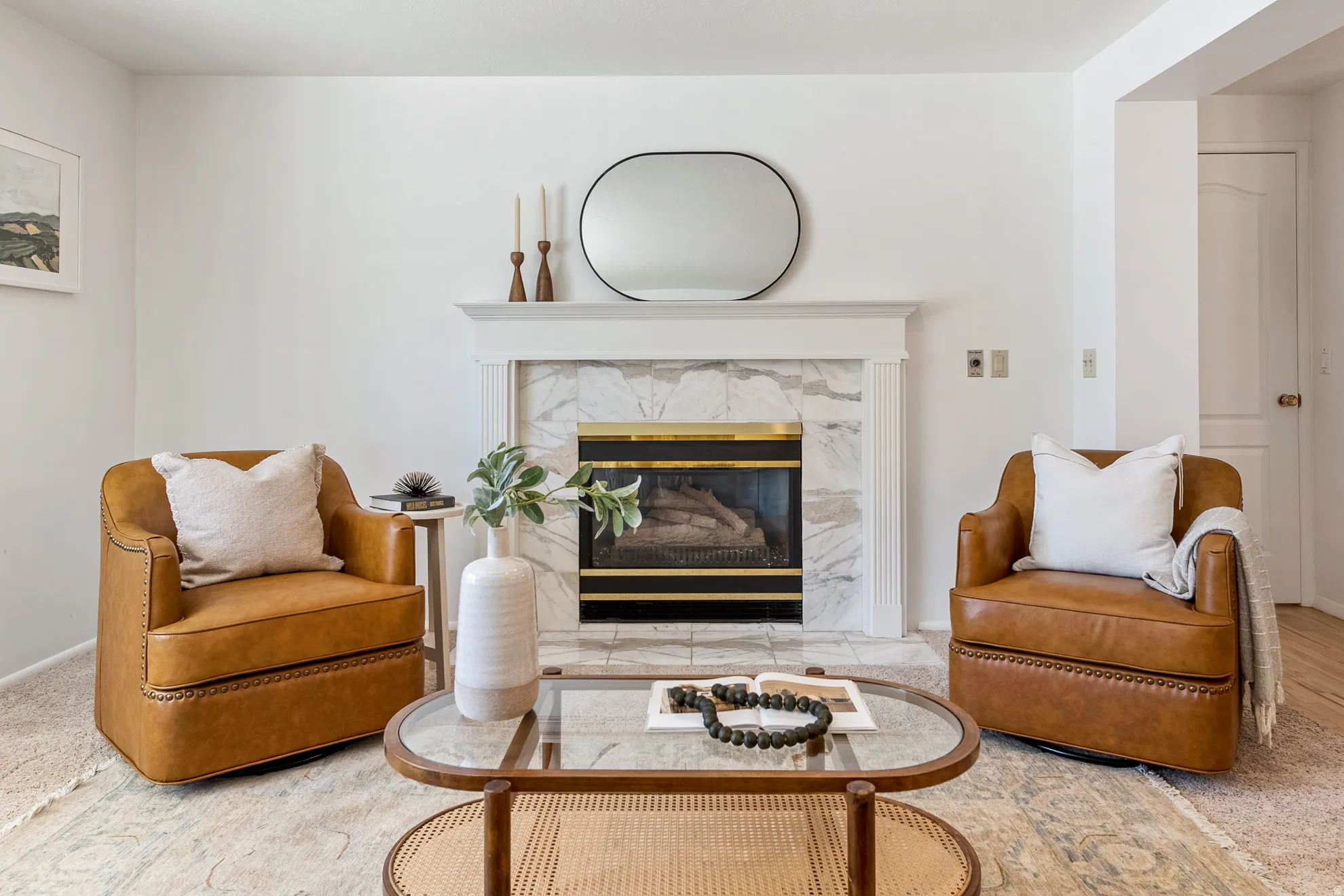 Fireplace featuring a classic white mantel, tile surround, and a brass-accented firebox