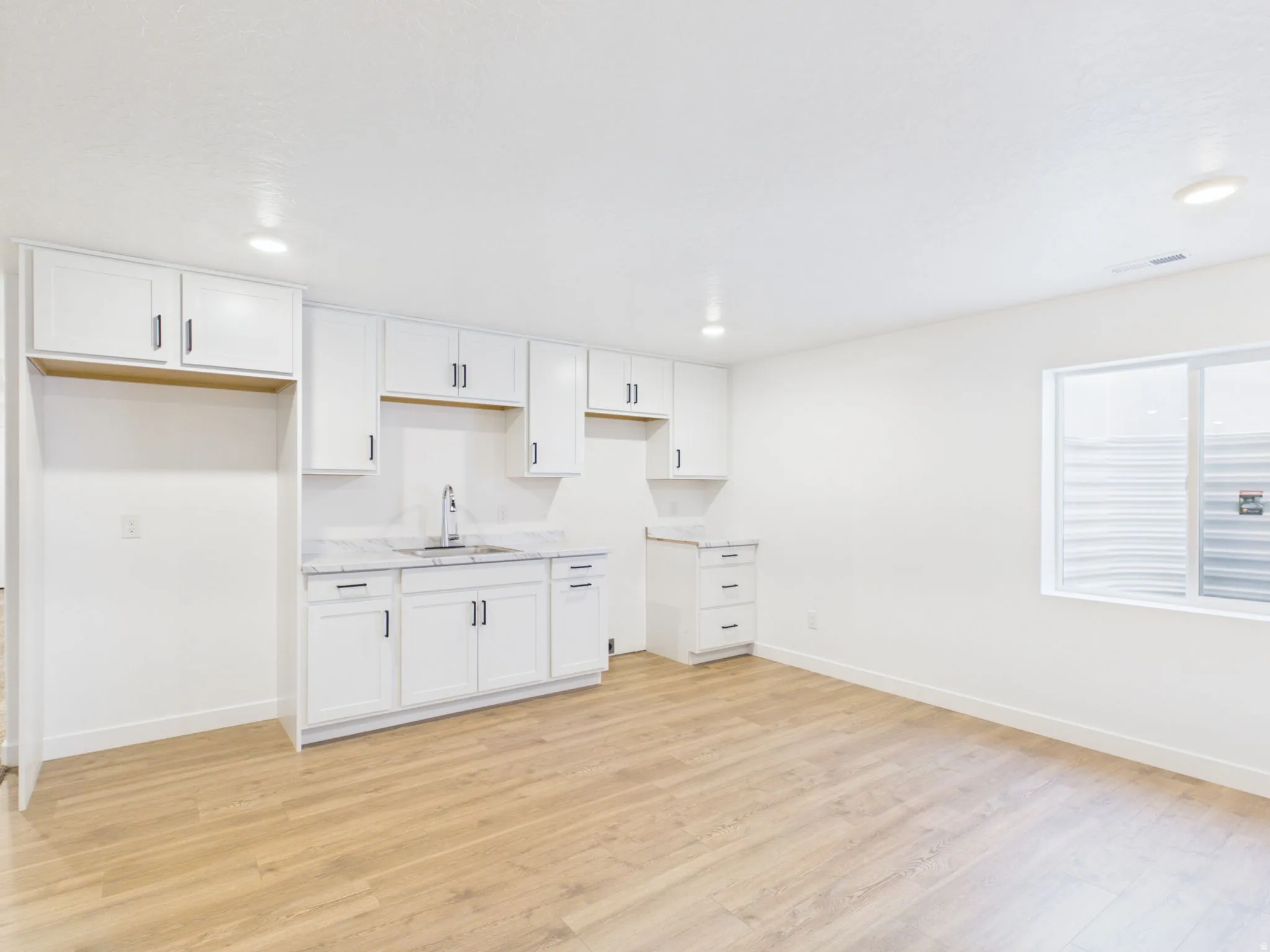 White cabinetry with matte black hardware