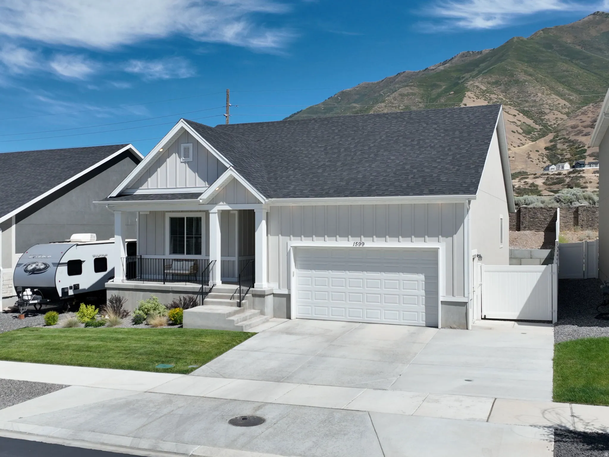 Contemporary single-story residence with a covered porch, attached garage, and a gabled roofline
