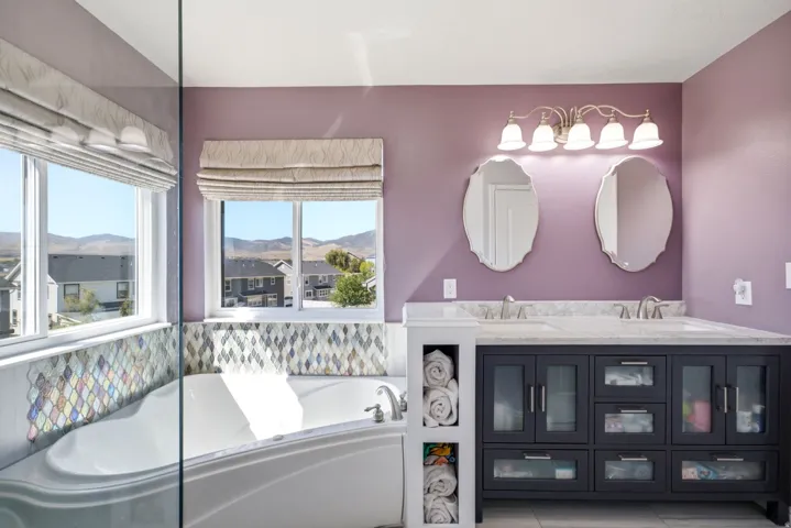 Dual vanity with undermount sinks, stone countertops, and dark wood-finish cabinetry