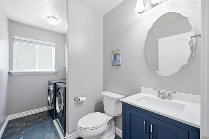 Navy blue vanity with an integrated sink and brushed nickel faucet