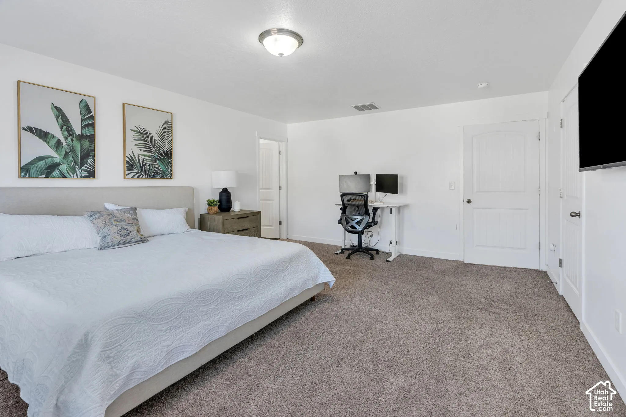 Carpeted flooring, recessed lighting, and a neutral color palette