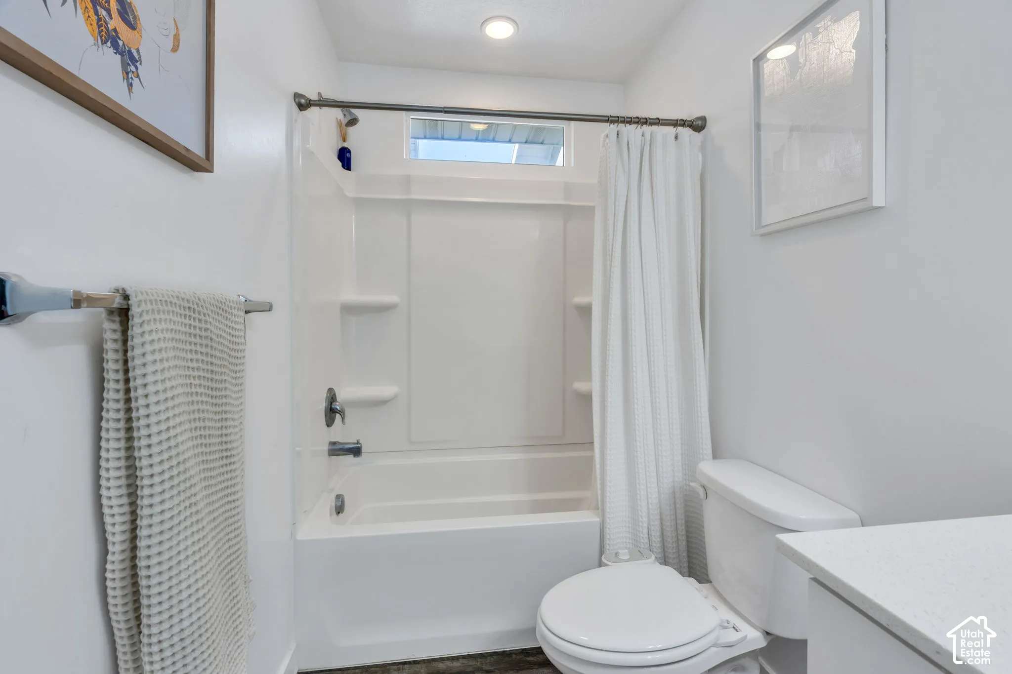Full white bathtub/shower combination with integrated shelving