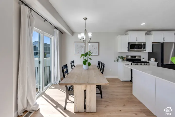 Kitchen featuring white cabinetry, stainless steel appliances, and a central island with a solid surface countertop