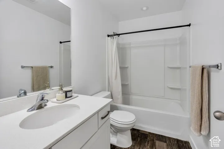 White vanity with an integrated sink, polished chrome faucet, and a large wall mirror