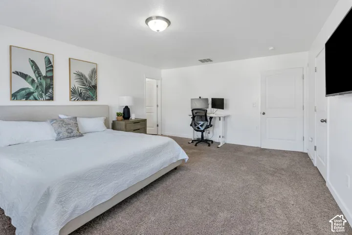 Carpeted flooring, recessed lighting, and a neutral color palette