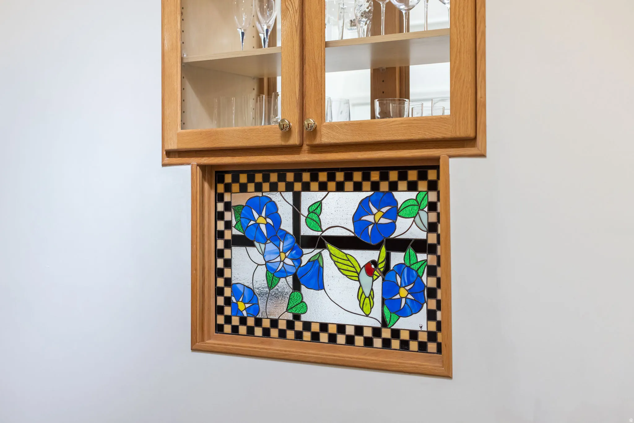 Oak cabinetry with glass-front doors