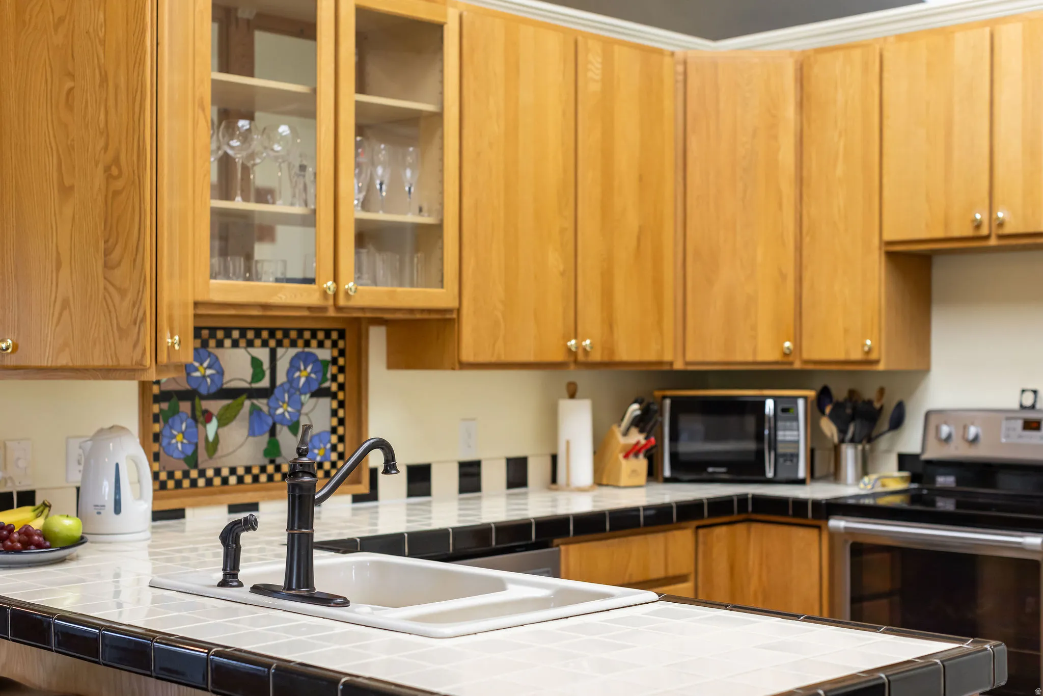 Light wood cabinetry with glass-front accents
