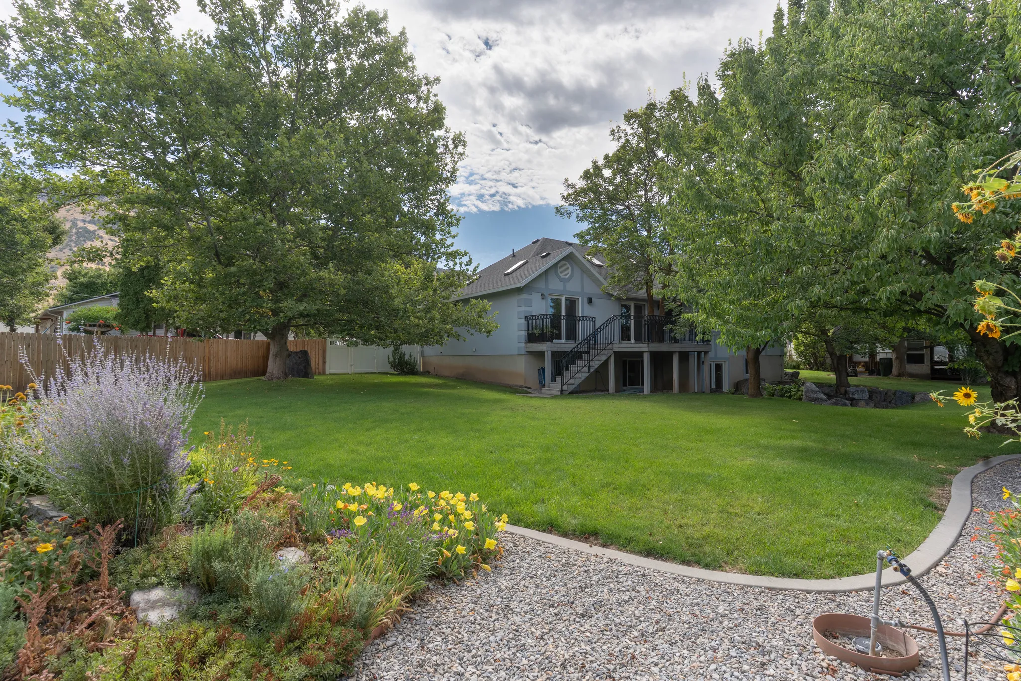 Expansive lawn area with mature trees and established landscaping