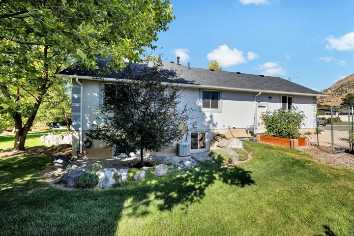 Manicured lawn with mature trees and rock landscaping