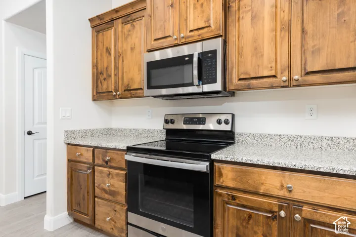 Wood-finish cabinetry paired with light-toned speckled countertops