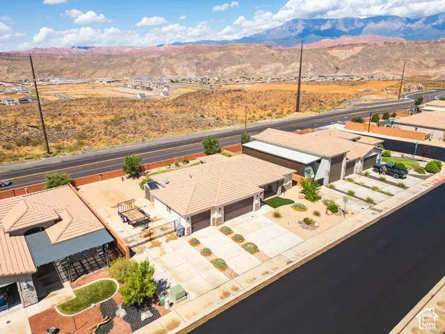Southwestern architecture featuring a tiled roof, stucco exterior, and attached garages
