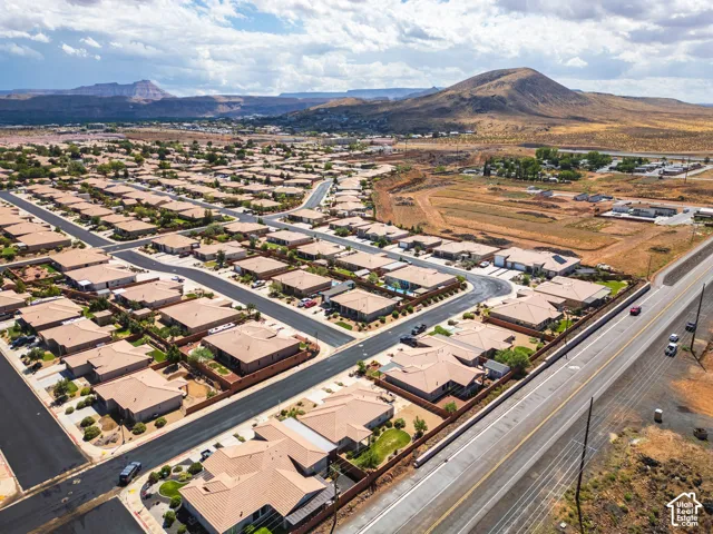 Residential community with consistent architecture, paved streets, and desert landscaping