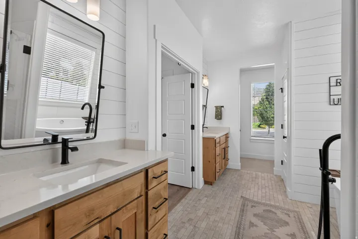 Dual vanities with integrated sinks and matte black fixtures