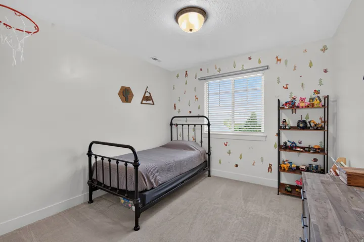White painted walls with a single window featuring horizontal blinds
