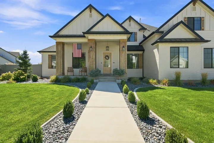 White brick and board-and-batten exterior with dark trim accents