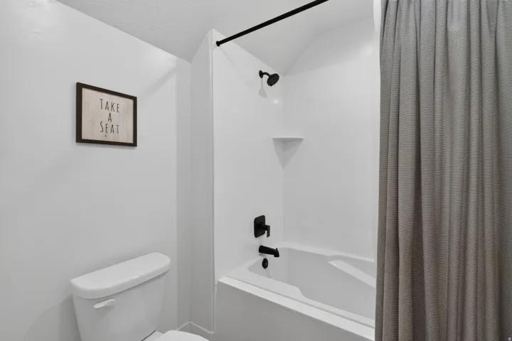White tub-shower combination with matte black fixtures