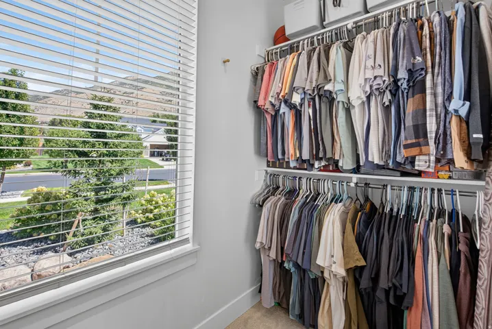 Built-in closet organization system with multiple hanging rods and shelving