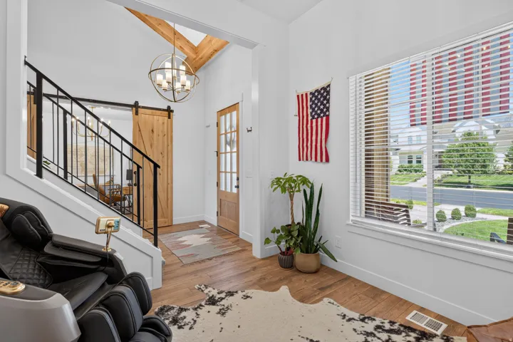 Wood-finish flooring, white walls, and a wood-paneled barn door