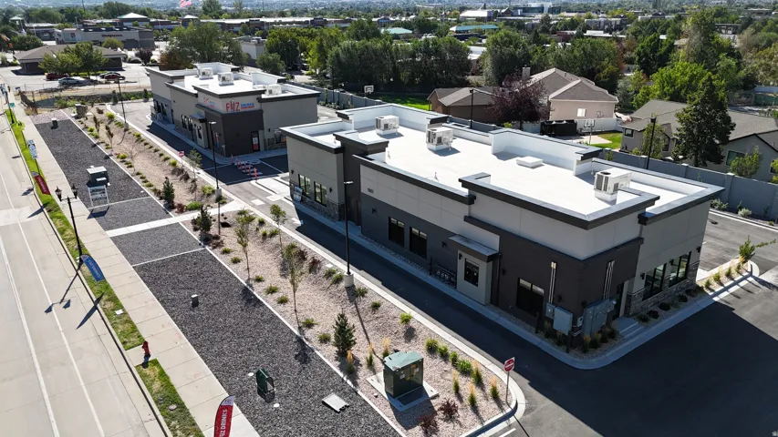 Contemporary building exterior featuring a flat roof and multiple large windows