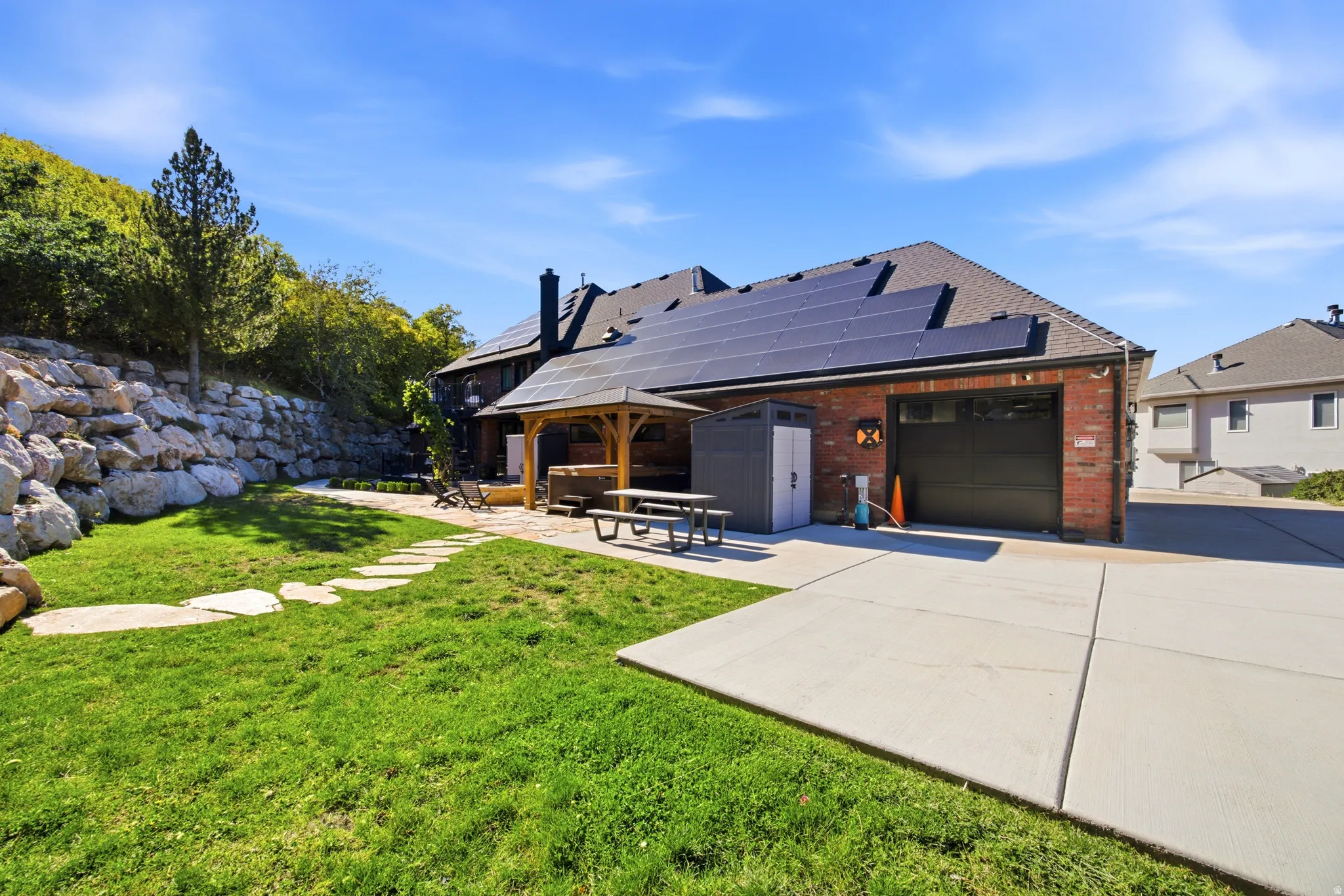 Red brick exterior with an attached garage, featuring rooftop solar panels