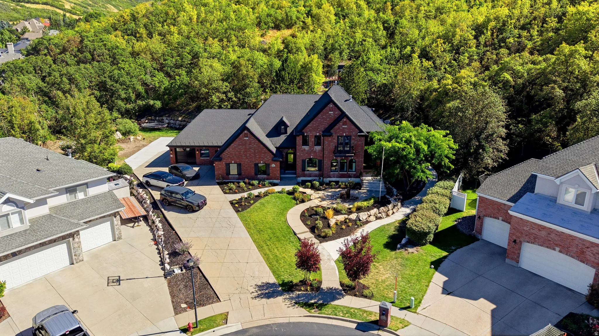Brick exterior with dark trim accents, multiple gables, and an attached two-car garage