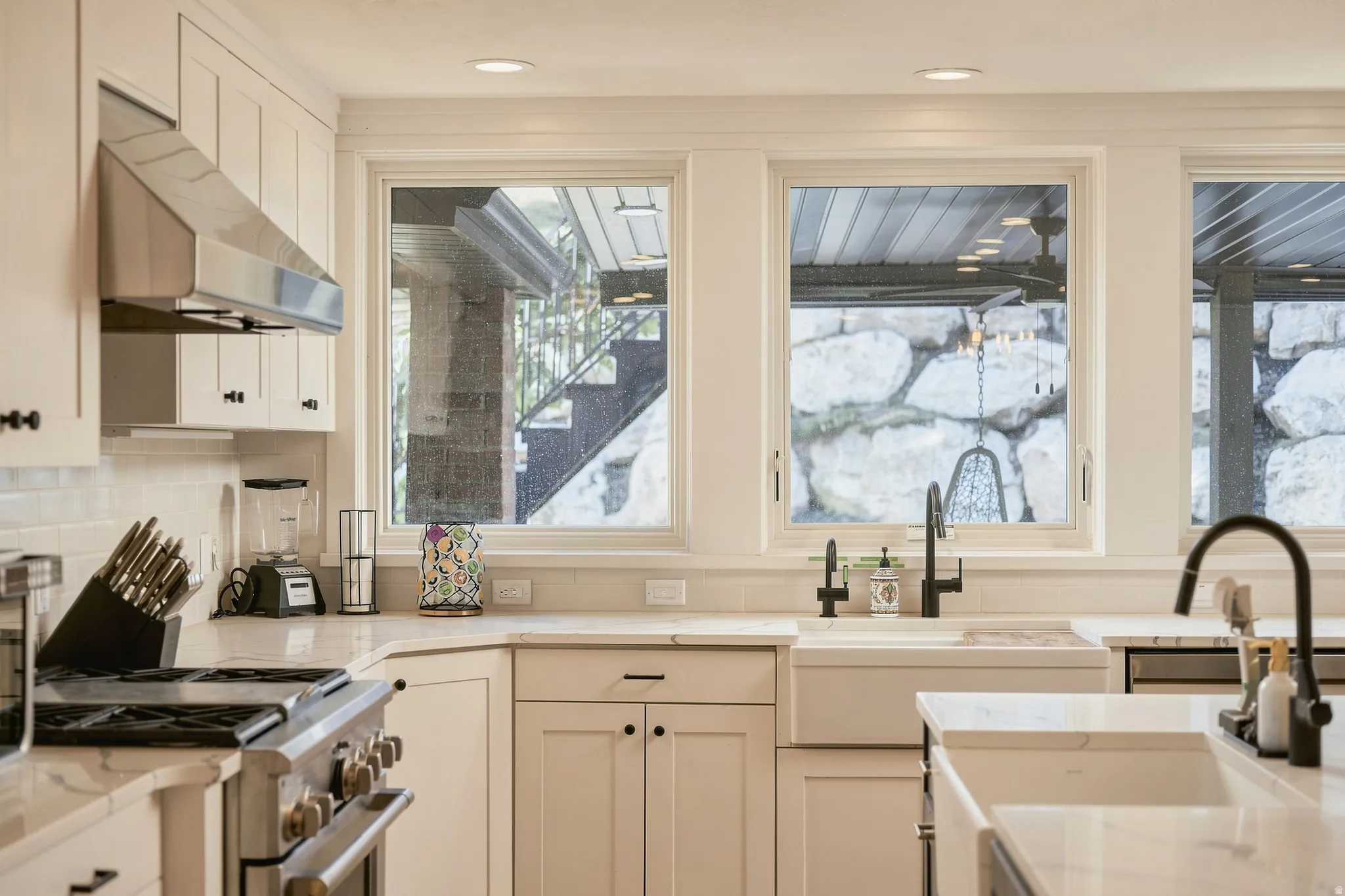 White shaker cabinetry complemented by a subway tile backsplash and recessed lighting