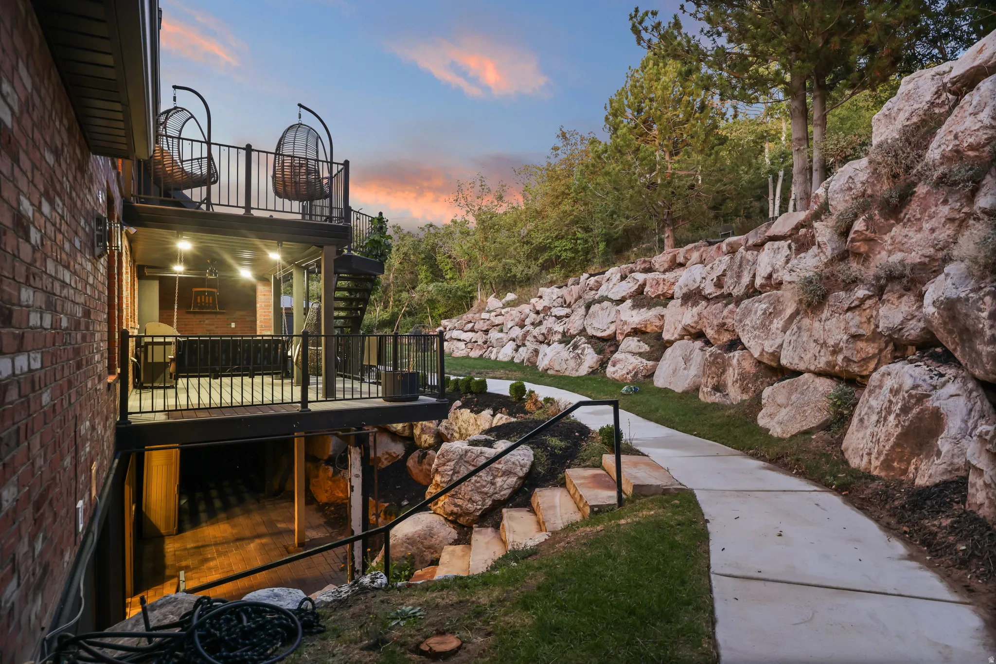 Brick exterior with multi-level decks featuring black railings