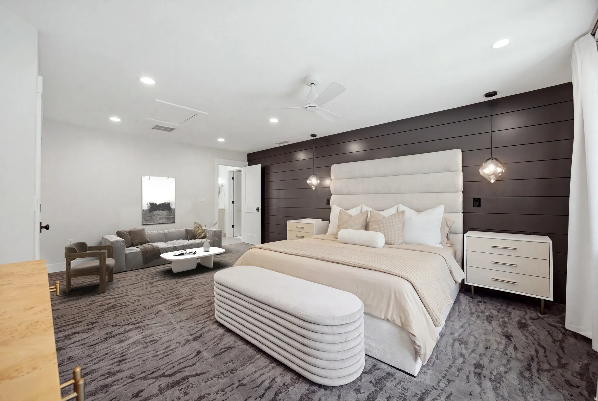 Recessed lighting, ceiling fan, dark shiplap accent wall, two pendant lights, and a door leading to another room