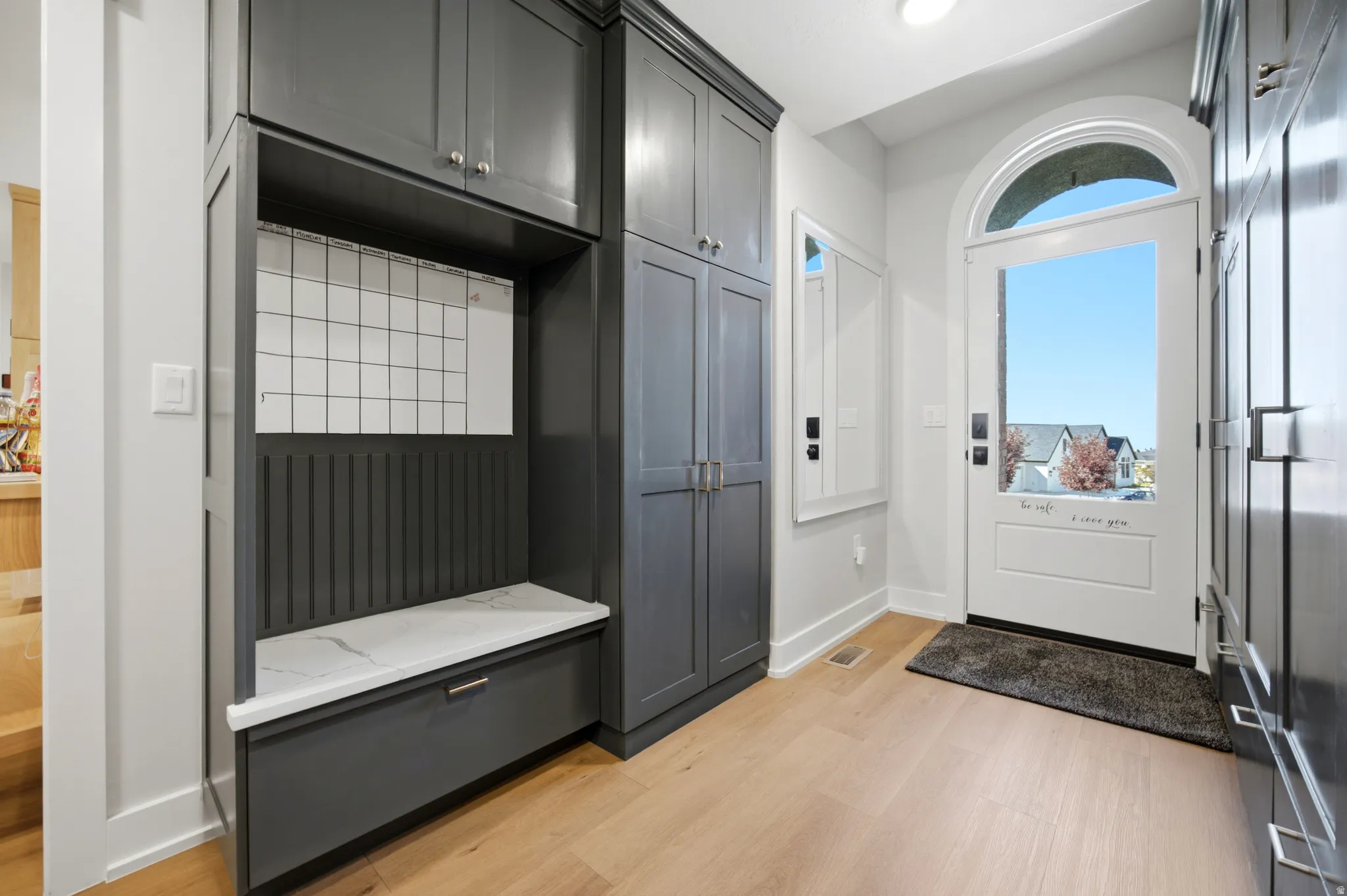 White arched entry door with clear glass