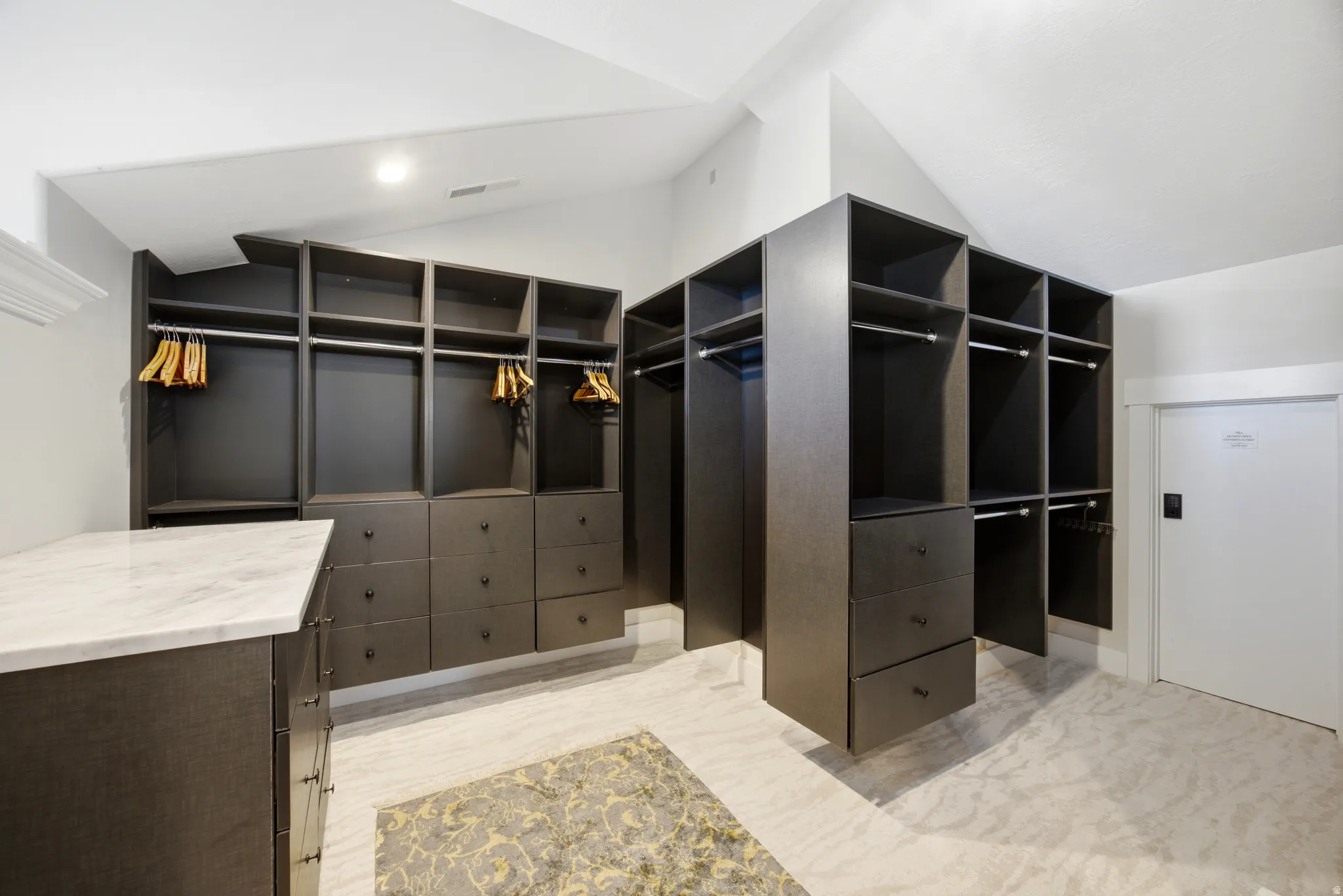 Custom built-in closet system with multiple shelving units, hanging rods, and integrated drawers