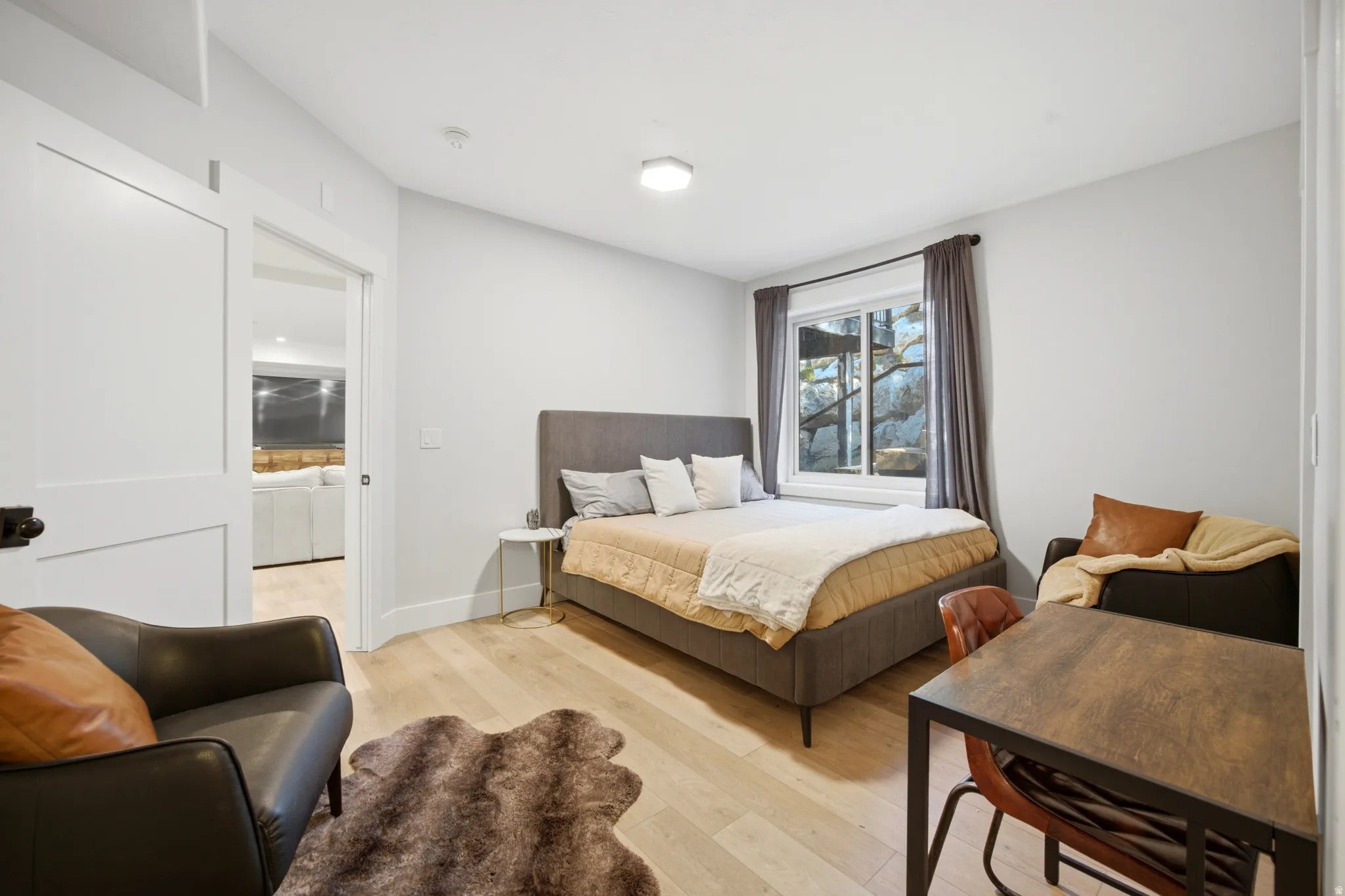 White walls, wood-finish flooring, and a sliding two-panel door