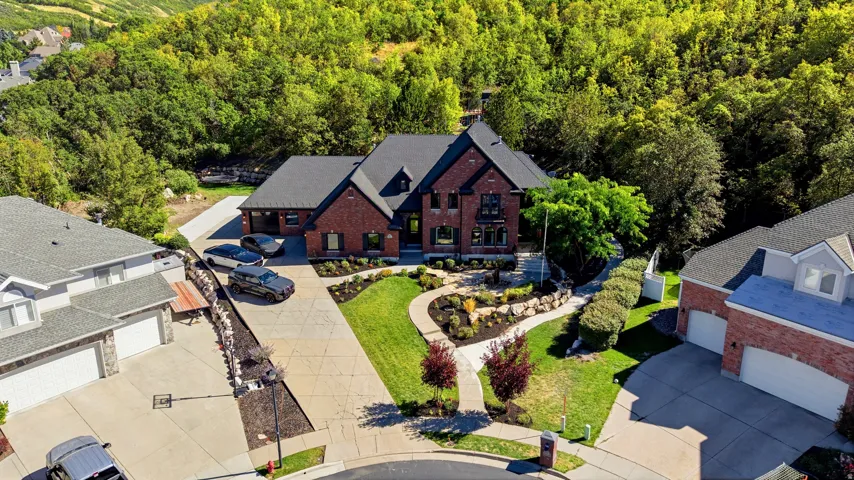 Brick exterior with dark trim accents, multiple gables, and an attached two-car garage